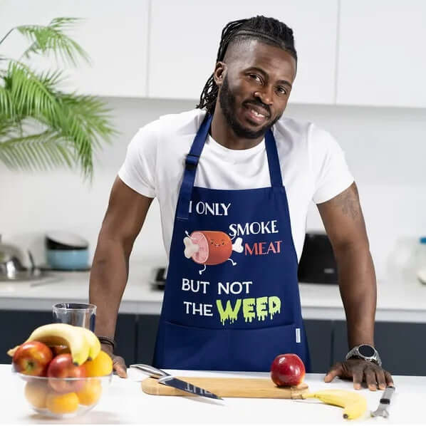 Person wearing a blue apron with text and graphics in a kitchen setting