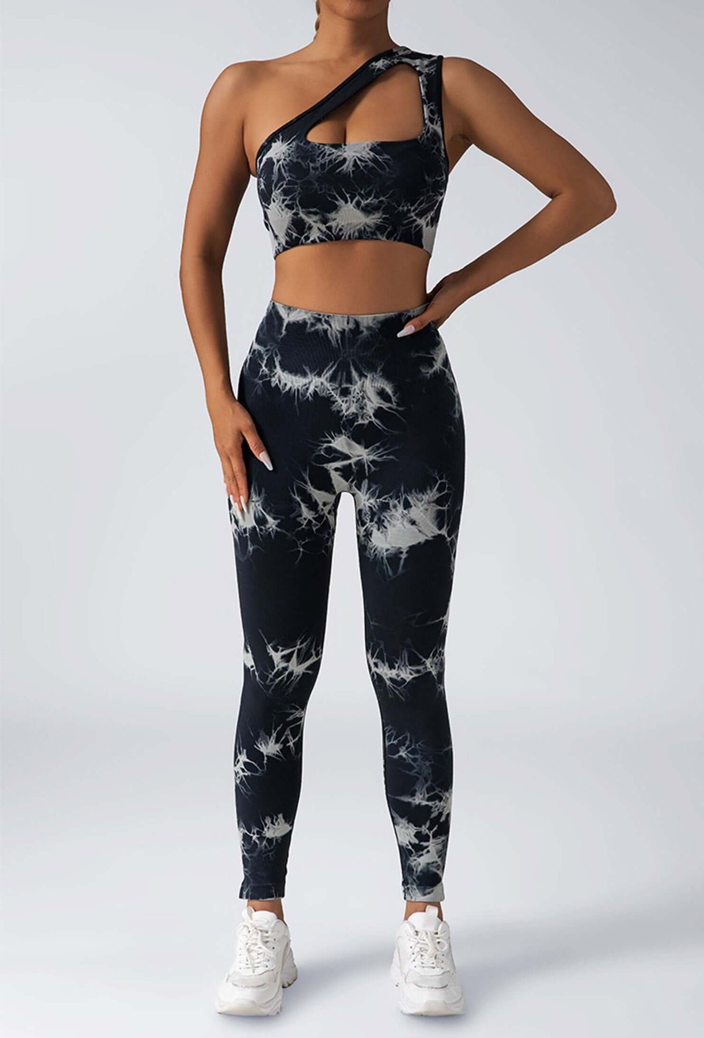 Person wearing a black and white tie-dye athletic outfit on a plain background