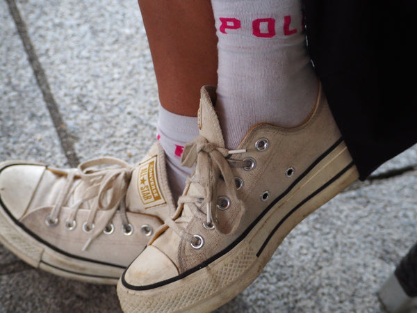 a close up of a person's shoes with socks on