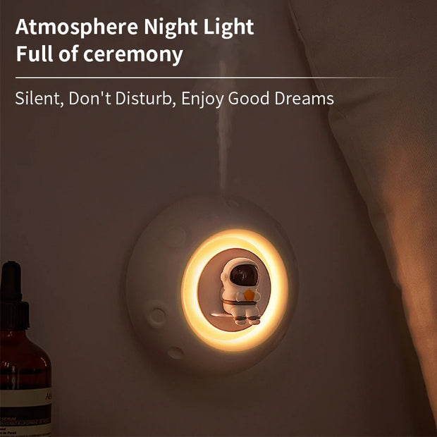 Night light with a character design on a wall in a bedroom setting.