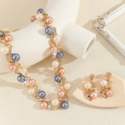 Pearl necklace and earrings set on a beige background