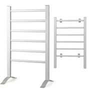 White towel rack with a blue towel hanging on it next to a white bathtub in a bathroom.
