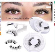 Eyelashes with a white clip and packaging on a white background