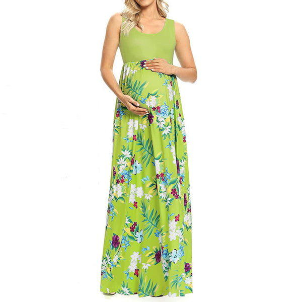Woman wearing a green floral maxi dress on a white background