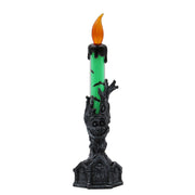 Decorative candle with green wax and black holder on a white background