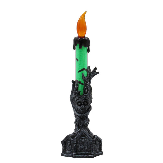 Decorative candle with green wax and black holder on a white background