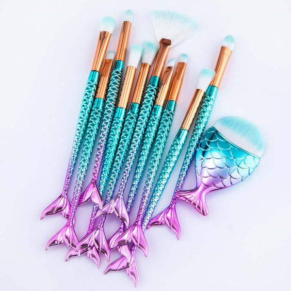 Set of makeup brushes with mermaid tail design on a light gray background