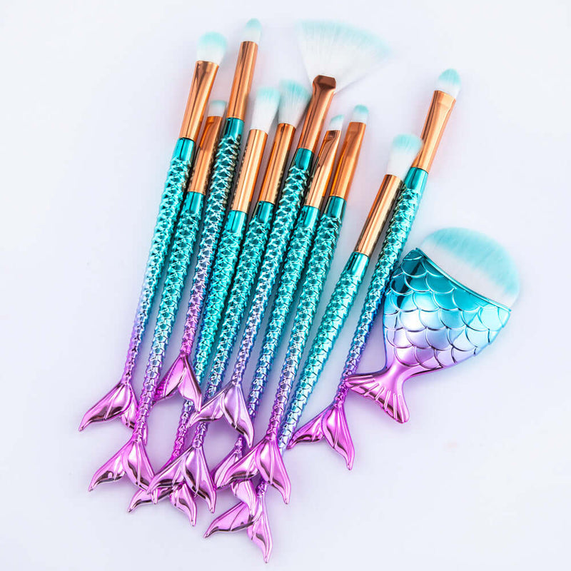 Set of makeup brushes with mermaid tail design on a light gray background