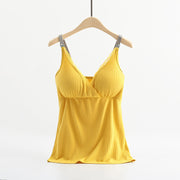 Yellow pleated top on a hanger against a white background