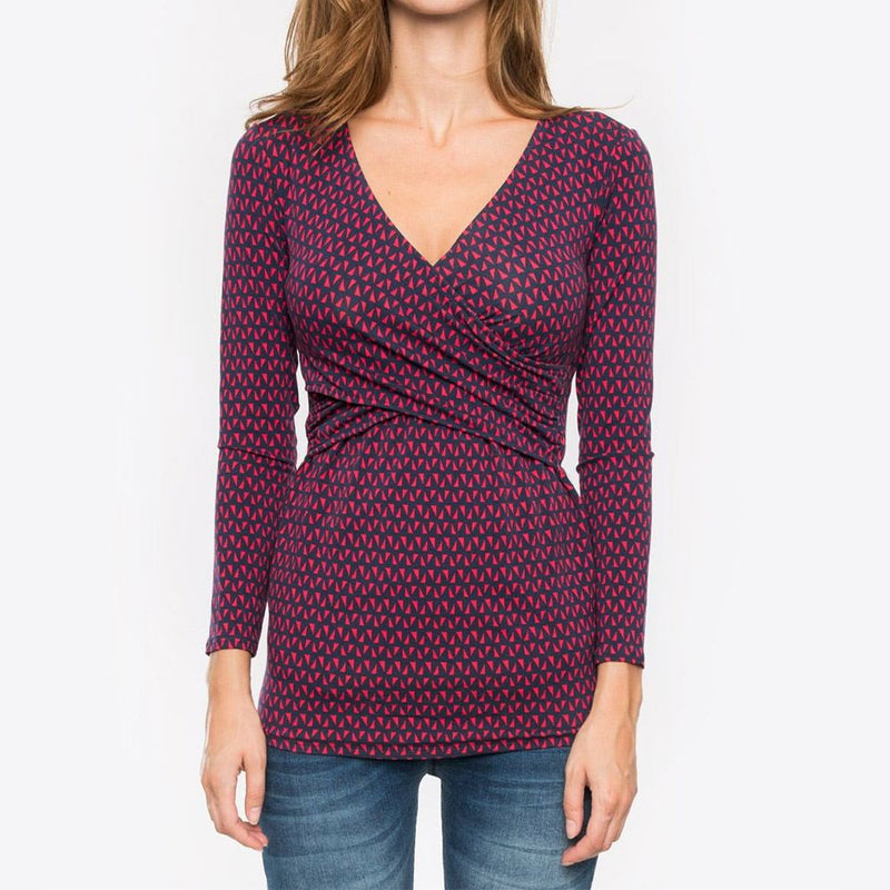 Woman wearing a patterned long-sleeve top on a white background