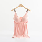 Pink satin camisole on a wooden hanger against a white background