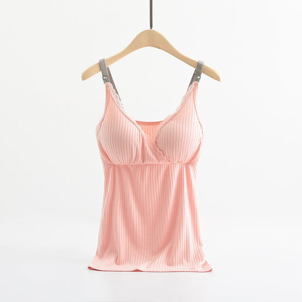 Pink satin camisole on a wooden hanger against a white background