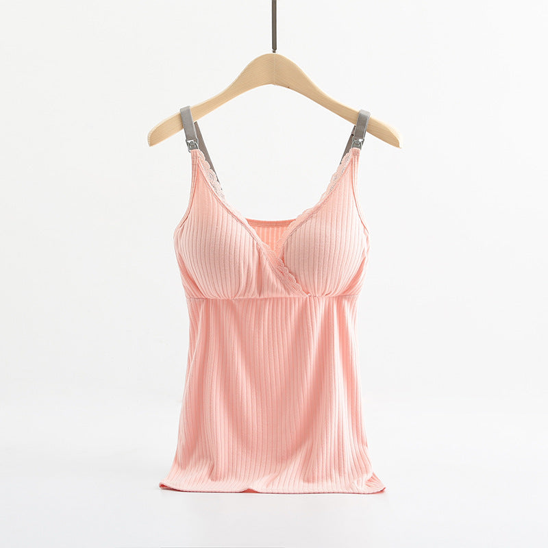 Pink satin camisole on a wooden hanger against a white background