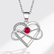 Heart-shaped silver necklace with a red gemstone and engraved text on a white background
