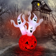 Halloween inflatable decoration with ghosts and a pumpkin in front of a haunted house.