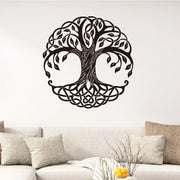 Decorative wall sticker of a tree design on a white wall above a sofa.