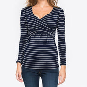Navy and white striped long-sleeve top worn by a person on a white background