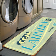 Laundry mat with 'Coin Laundry' text in front of washing machines