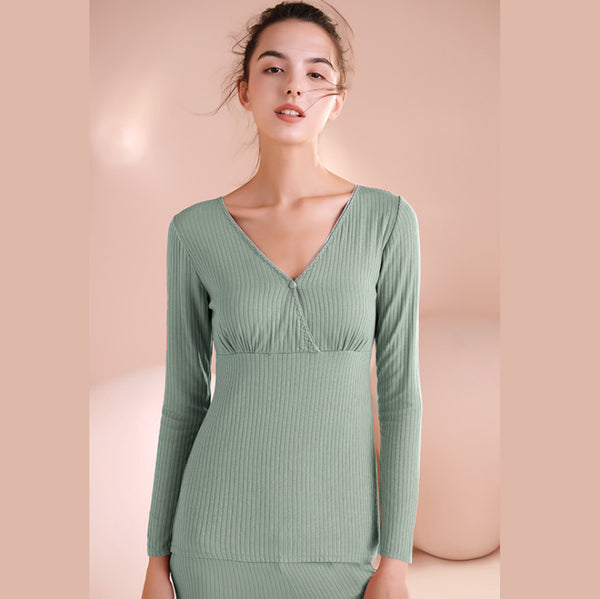 Woman wearing a green dress against a beige background