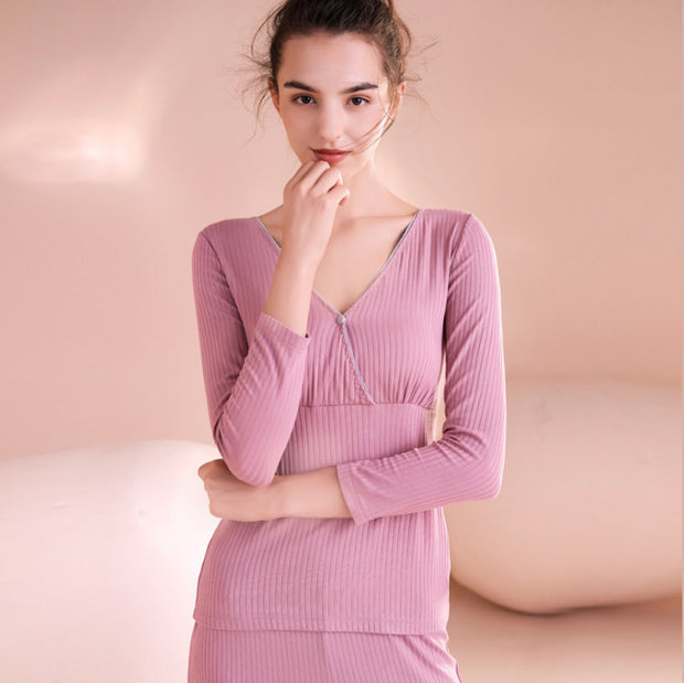 Woman wearing a pink ribbed dress against a soft pink background
