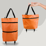 Orange tote bag with black straps on a gray background