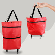 Red shopping bag with black straps and wheels on a gray background