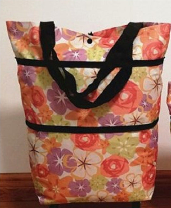 Floral-patterned tote bag with black handles on a plain background