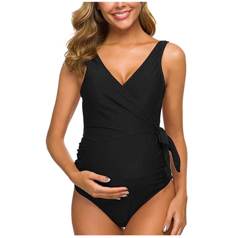 Woman wearing a black one-piece swimsuit on a white background