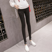 Person wearing black leggings and white shoes in a wine cellar setting