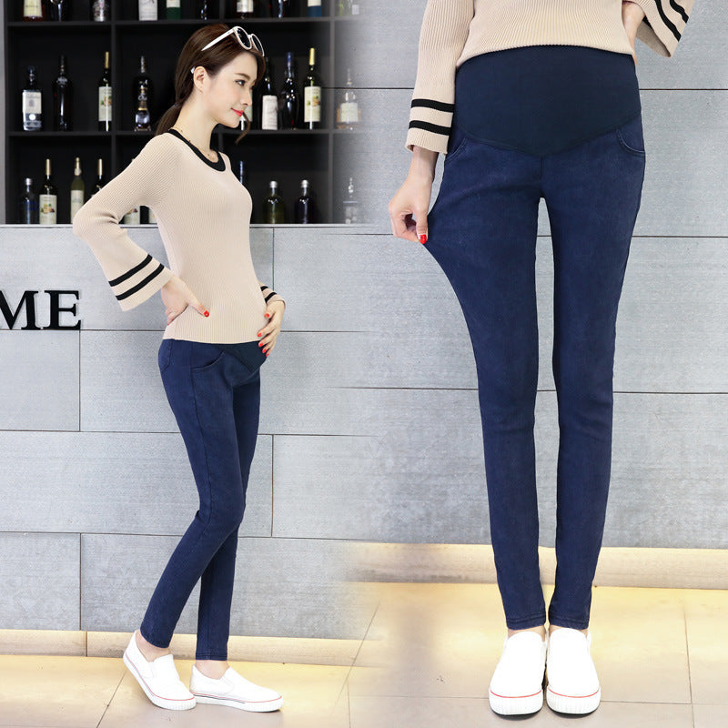 Woman wearing navy blue leggings with a neutral sweater in a store setting.