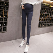 Person wearing dark blue leggings and white sneakers in a wine cellar.