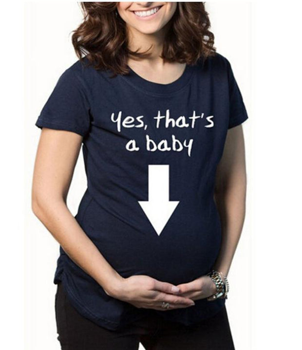 Navy blue t-shirt with 'Yes, that's a baby' text and arrow graphic worn by a person.