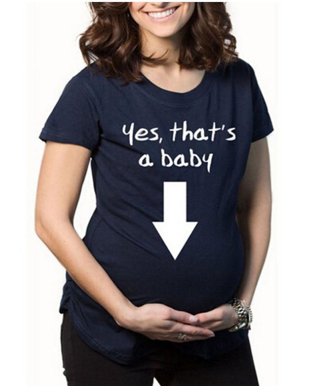 Navy blue t-shirt with 'Yes, that's a baby' text and arrow graphic worn by a person.