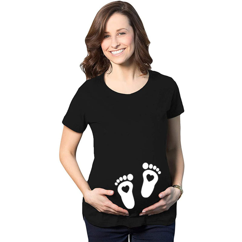 Woman wearing a black t-shirt with white footprints on a white background