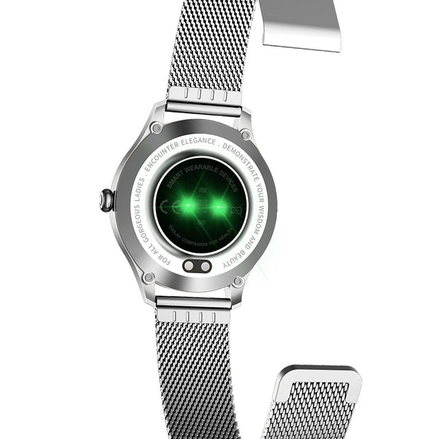 Silver smartwatch with green display on a white background