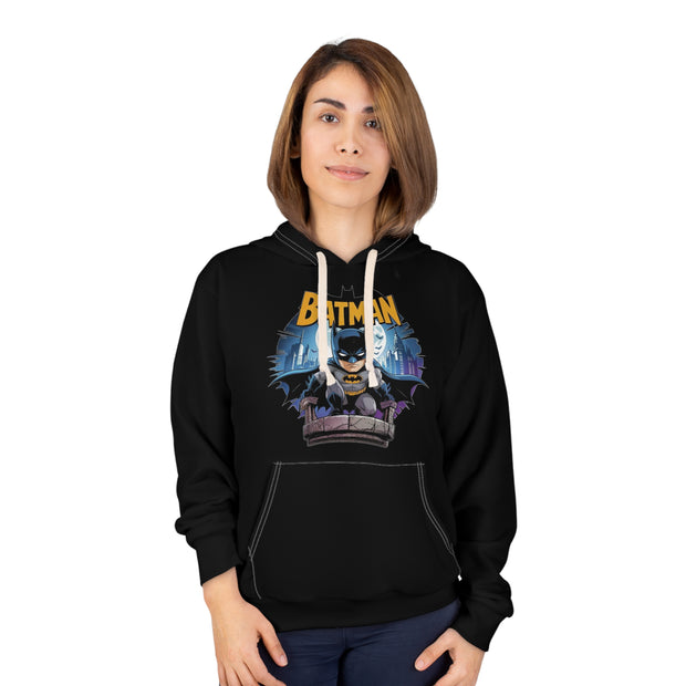 Person wearing a black hoodie with Batman graphic design on a white background