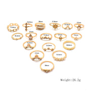 Collection of gold rings with measurements on a white background