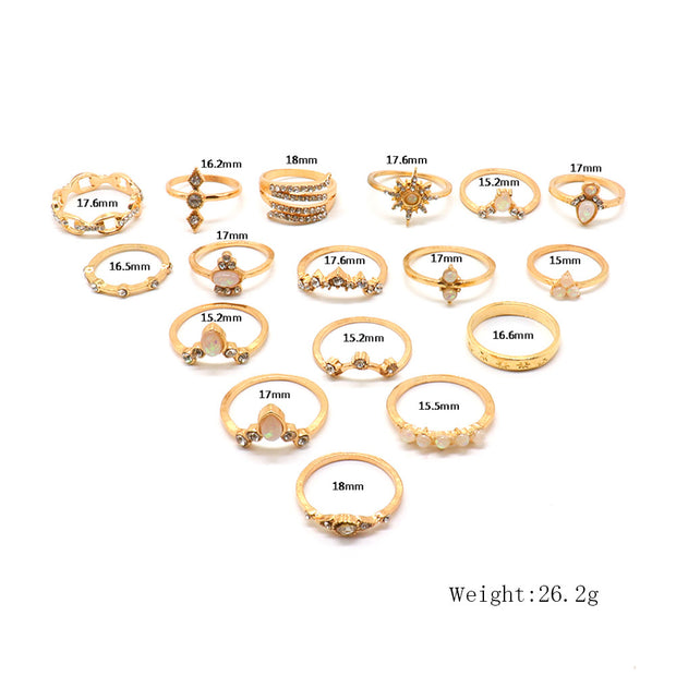 Collection of gold rings with measurements on a white background