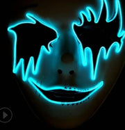 Neon blue mask with a dark background