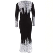 Black dress with white sequin detailing on a white background