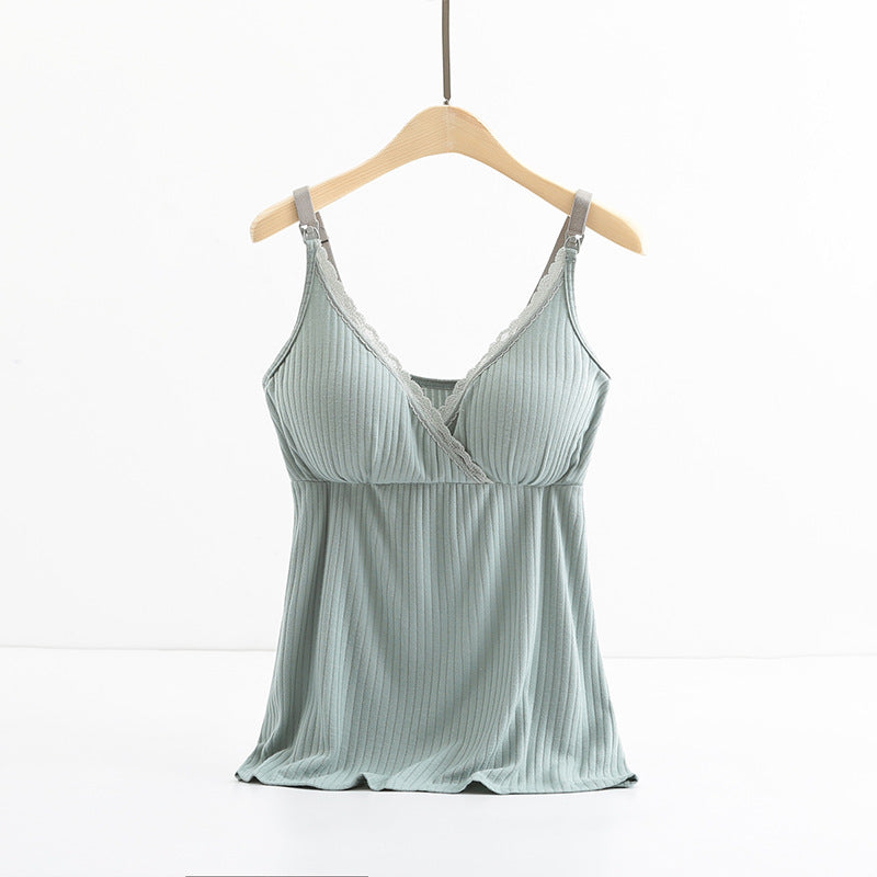 Light blue satin camisole on a wooden hanger against a white background