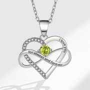 Silver heart-shaped pendant with a green gemstone and 'I love you' engraving on a white background