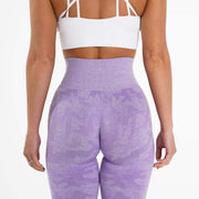 Rear view of a woman wearing brand name purple yoga leggings showcasing comfort and style.