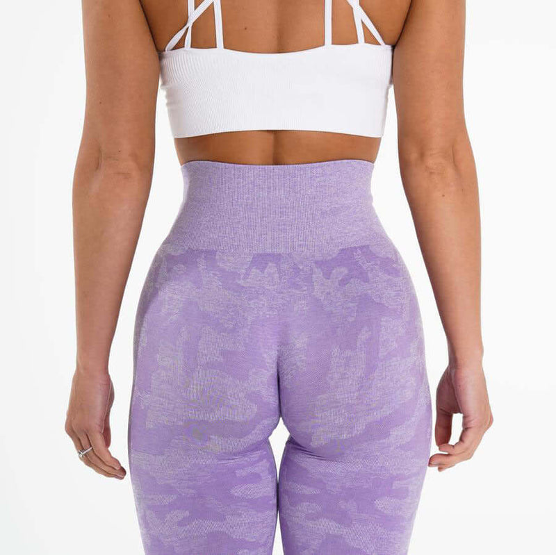 Rear view of a woman wearing brand name purple yoga leggings showcasing comfort and style.