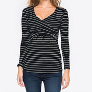 Black and white striped long-sleeve top worn by a person on a plain background