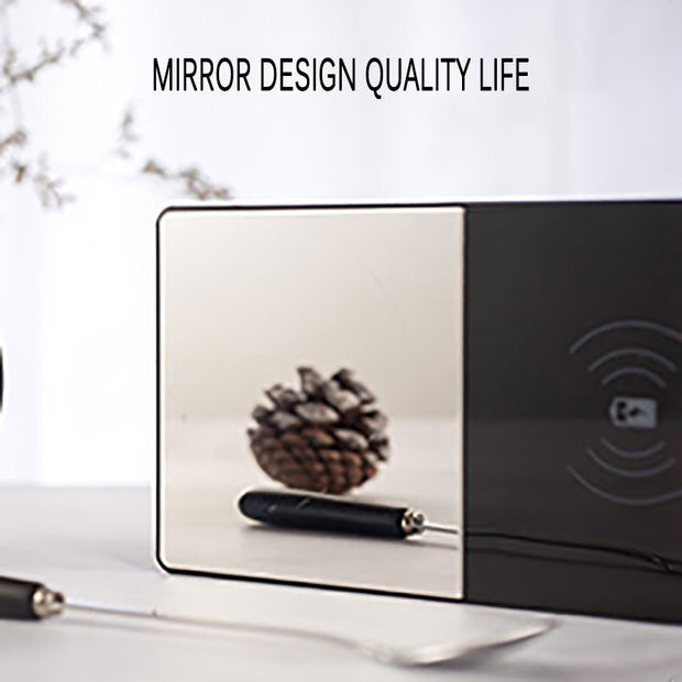 Wireless charging pad with a pine cone on a reflective surface, with 'Mirror Design Quality Life' text.