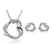Heart-shaped jewelry set with necklace and earrings on a white background