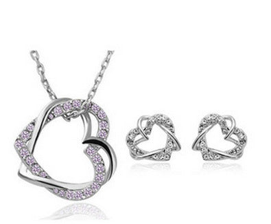 Heart-shaped jewelry set with necklace and earrings on a white background