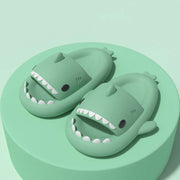 Cute green shark slippers designed for fun indoor and outdoor wear, featuring cartoon shark shape and comfortable fit.