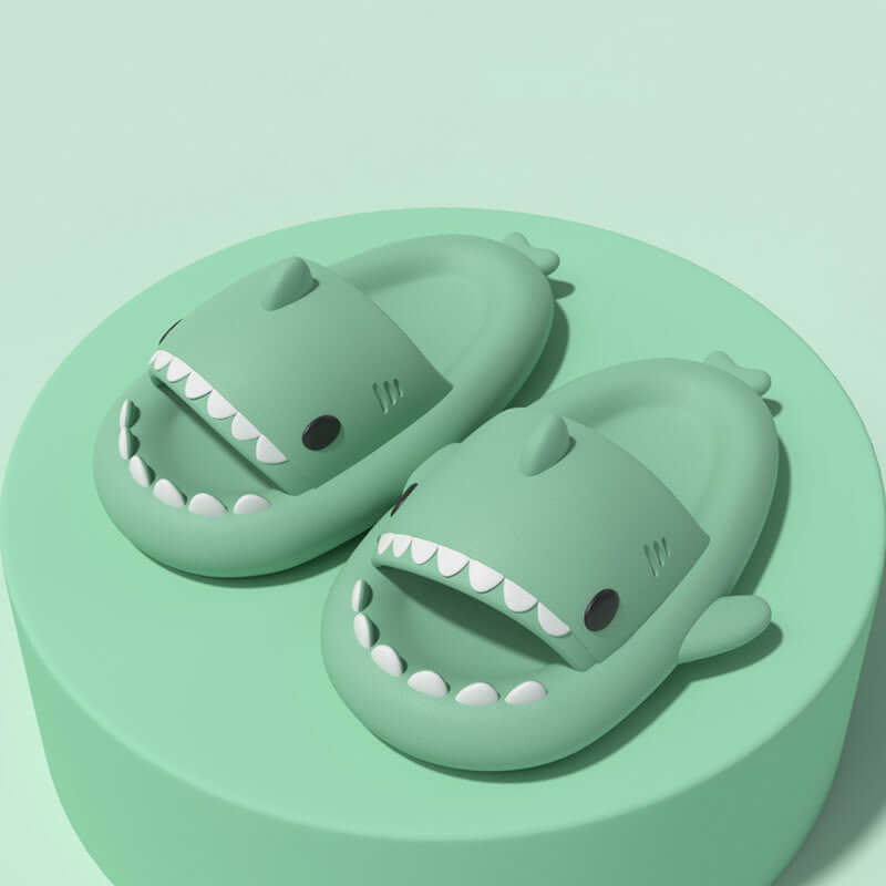 Cute green shark slippers designed for fun indoor and outdoor wear, featuring cartoon shark shape and comfortable fit.